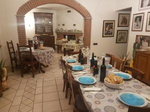 a dining room with a table with blue plates on it at La Crota in Asti