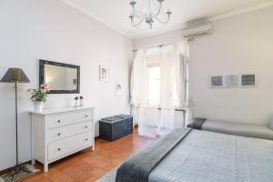 a bedroom with a bed and a dresser and a window at Finally Roma Apartment in Rome