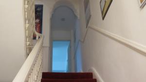 a stairway with a red stair case at Beach house in Crosby