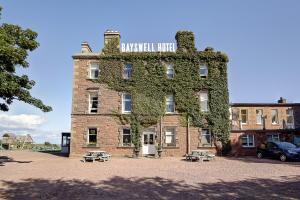 an old brick building with ivy growing on it at Bayswell Park Hotel in Dunbar