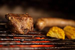 a piece of meat and other food on a grill at Can Barrina in Montseny