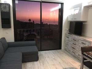 a living room with a couch and a view of the ocean at Golden Paradise Seaview in Adeje