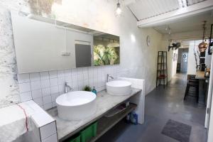 a bathroom with two sinks and a mirror at Stay SongSong Beach Street in George Town +26 photos