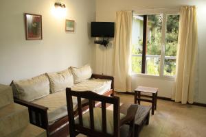 a living room with a couch and a window at Valeria Cielo in Valeria del Mar