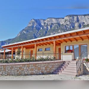 a house with a mountain in the background at Agriturismo L' Isola di Arturo in Trento