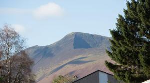 a mountain with a house in front of it at The Garden Apartment in Keswick