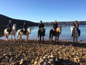 a group of people riding horses on a beach at provencal house with sunny terrace in Aups