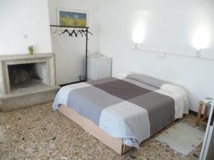 a bedroom with a bed and a fireplace at Appartamento Daniele in Mestre +3 photos