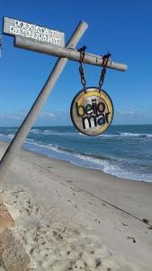 a street sign on the beach next to the ocean at Beijo Mar Beach Club in Tibau