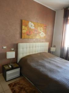 a bedroom with a bed and a painting on the wall at Casa Domenica - 200m dal mare in Ceriale +28 photos