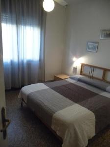 a hotel room with two beds and a window at Appartamento Franca in Mestre +4 photos
