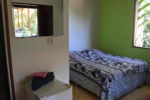 a bedroom with a bed and a window at Pousada O Canto das Sereias in Trindade