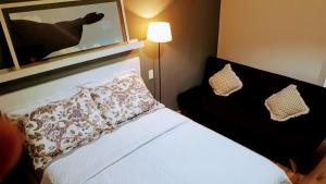 a bedroom with a bed with a pillow on it at Loft Copacabana Avenida Atlantica in Rio de Janeiro