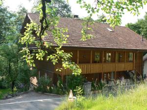 a large wooden house with at B3 Boutique-Bed&Breakfast in Gsteigwiler