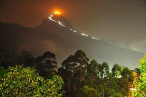a mountain with a light on top of it at night at Tea Hills Bungalow in Hatton