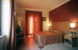 Postel nebo postele na pokoji v ubytování Hotel Tenda Rossa