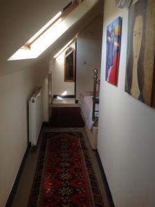 a hallway with a room with a bed and a rug at Maescelyn in Aberystwyth