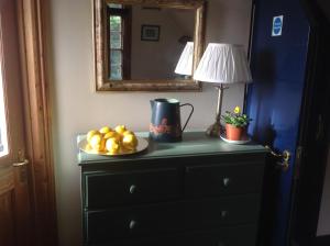 a table with a plate of fruit on top of a dresser at Maescelyn in Aberystwyth