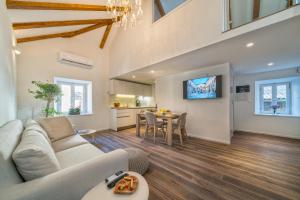 a living room with a couch and a table at Feel like an Emperor Apartments in Split