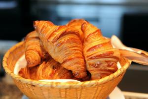 a basket filled with croissants and other pastries at La Dimora dei sette Arcangeli in Palermo