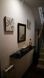 a hallway with a mirror and a stair case at Atico en centro Ribes de Freser in Ribes de Freser