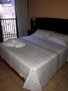 a bedroom with a bed with white sheets and a balcony at Hotel VegaSierra in Bogarra +35 photos