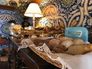 a table with a basket of bread and a lamp at Hotel Rural Casa dos Viscondes da Varzea in Lamego