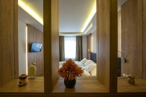 a view of a bedroom with a bed and a mirror at Penzión Berg in Kežmarok