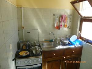 a small kitchen with a stove and a sink at Penthouse Télétravail in Mindelo