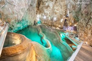 a large pool of blue water in a cave at Cabin Menka in Sirogojno