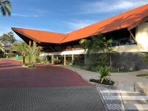 a building with an orange roof and a road at Marulhos resort Muro Alto in Porto De Galinhas