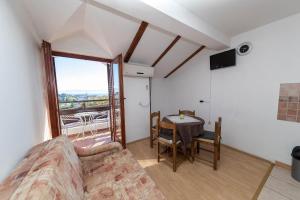 a living room with a couch and a table and a window at Apartments in Crikvenica 31165 in Crikvenica