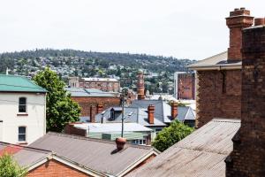 a large building with a clock on top of it at CBD Apartments Launceston in Launceston