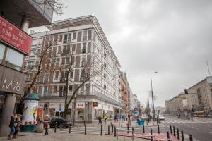 ワルシャワにあるCity Center Apartments Hoża by Rentersの歩道を歩く人々や建物が並ぶ街道