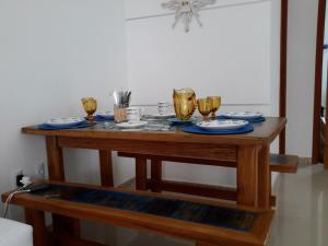 a wooden table with three glasses of wine on it at Ótima Localização - 4 Quartos in Porto Seguro