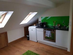 a kitchen with skylights and a sink and a stove at Modern ★★★★★ Top Floor Studio Apartment Getaway in London