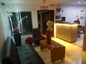 a living room with a couch and a table at Casa RyS Hotel in Ocotlán