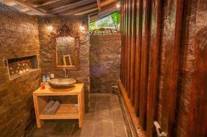 a stone bathroom with a sink and a mirror at Blu d'aMare in Gili Trawangan +51 photos