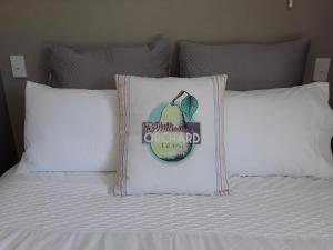 a bed with a pillow with a sign on it at Suite Petite in Taupo