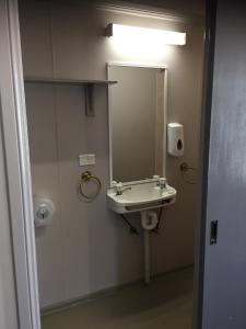 a bathroom with a sink and a mirror at Heritage Hotel Rockhampton in Rockhampton