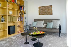 a living room with a couch and a table with a bowl of fruit at En Marge in Aureville