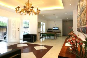 a living room with a chandelier and a dining room at Sun Rise House in Jakarta