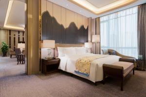 Ένα ή περισσότερα κρεβάτια σε δωμάτιο στο Wanda Realm Changzhou