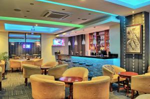 a restaurant with tables and chairs and a bar at After 40 Hotel in Nairobi +37 photos