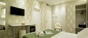 a hotel room with a bed and a television at Navigliotel 19 - Rooms & Suites in Milan