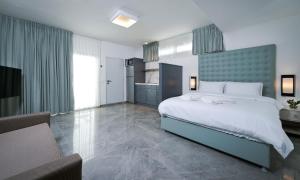 a bedroom with a large bed and a couch at Roni Suite in Eilat