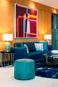 a living room with a blue couch and a table at Elite World Marmaris - Adult Only in Marmaris