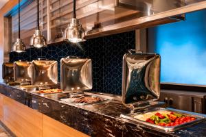 a kitchen with two trays of food on a counter at Elite World Marmaris - Adult Only in Marmaris