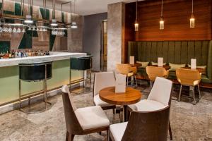 a restaurant with tables and chairs and a bar at Elite World Marmaris - Adult Only in Marmaris