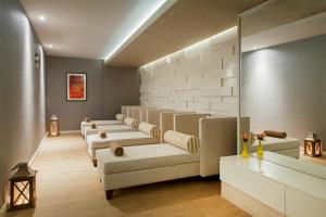 a waiting room with a row of white couches at Elite World Marmaris - Adult Only in Marmaris